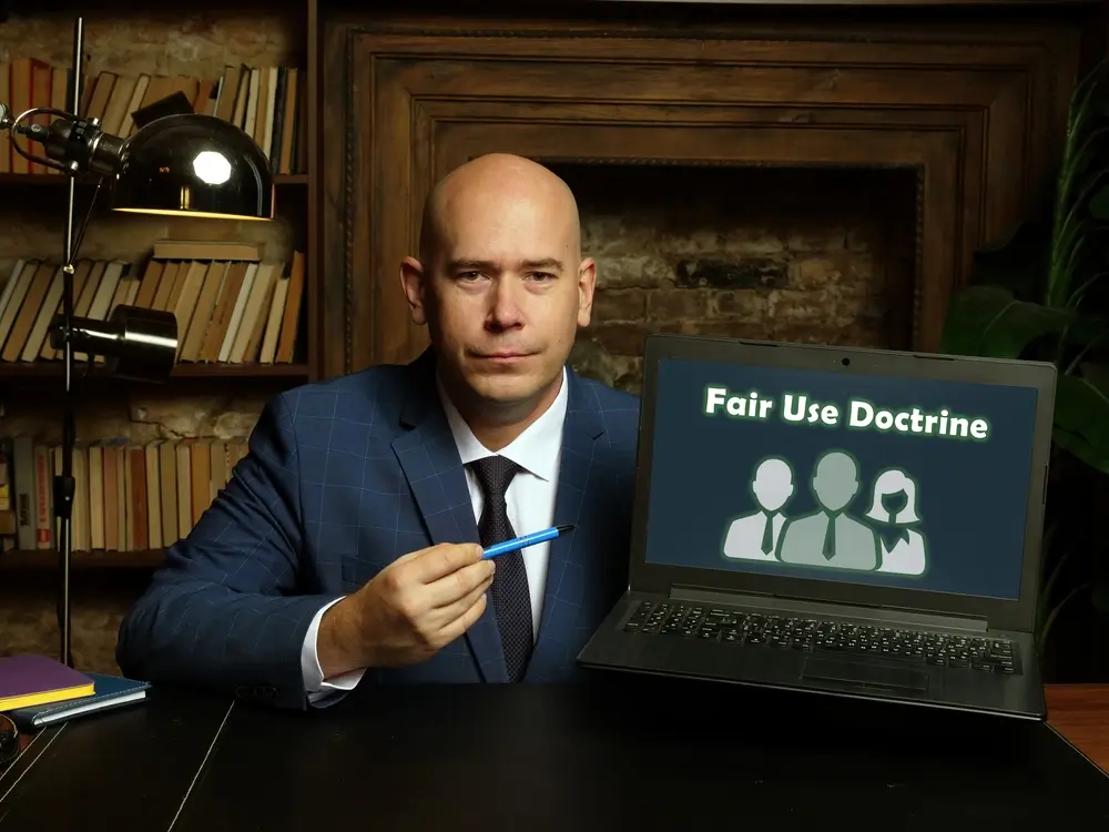 lawyer pointing to laptop describing fair use